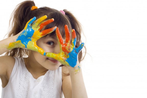 beautiful girl playing with colors on white background